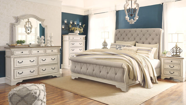 Ashley Realyn - Two-tone - 6 Pc. - Dresser, Mirror, Chest, California King Upholstered Sleigh Bed